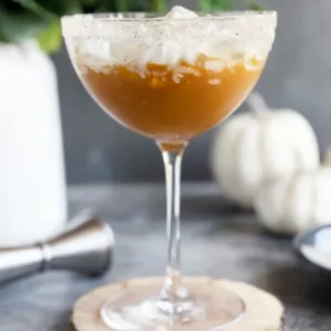 this image shows a wine glass full with Pumpkin Spice Martini With Whipped Cream